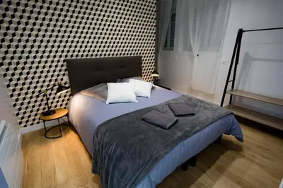 Un ou plusieurs lits dans un hébergement de l'établissement Domaine du Vendangeoir - Les Chambres