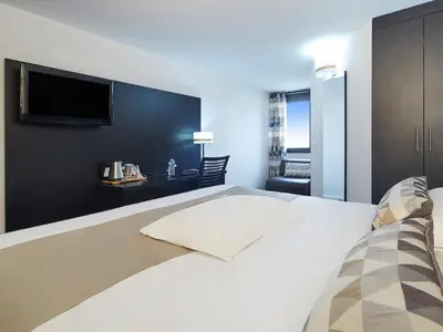 Un ou plusieurs lits dans un hébergement de l'établissement Kyriad Hotel Meaux