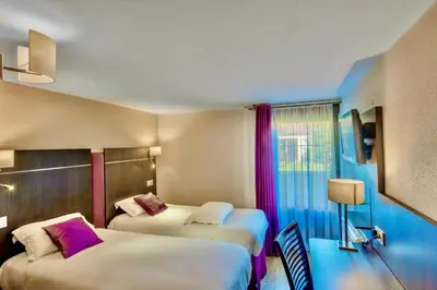 Un ou plusieurs lits dans un hébergement de l'établissement Kyriad Hotel Meaux
