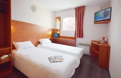 Un ou plusieurs lits dans un hébergement de l'établissement Brit Hotel Reims La Pompelle