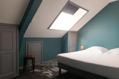 Un ou plusieurs lits dans un hébergement de l'établissement Hôtel Bristol Reims