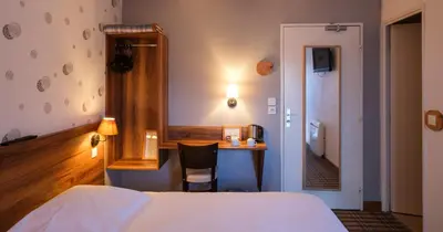 Un ou plusieurs lits dans un hébergement de l'établissement Cit'Hotel Le Montreal