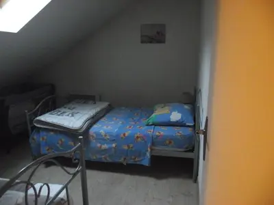 Un ou plusieurs lits dans un hébergement de l'établissement Maison chez Coco