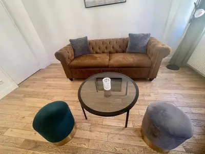 Coin salon dans l'établissement Charming Central Apartment - Reims