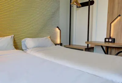Un ou plusieurs lits dans un hébergement de l'établissement B&B HOTEL Reims Bezannes