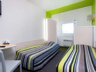 Un ou plusieurs lits dans un hébergement de l'établissement ENZO HOTELS 1er PRIX CHARLEVILLE