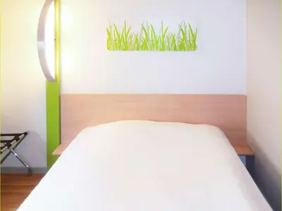 Un ou plusieurs lits dans un hébergement de l'établissement Hôtel Inn Design Laon