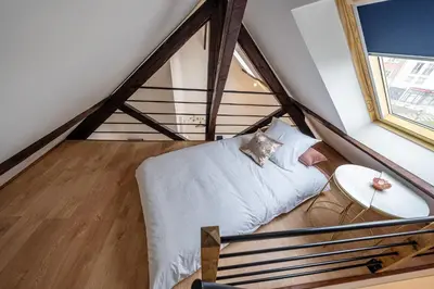 Un ou plusieurs lits dans un hébergement de l'établissement Le Magnifique Appart'Hotel Le Gatsby