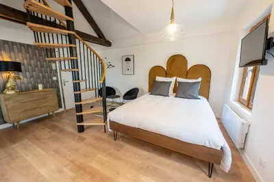 Un ou plusieurs lits dans un hébergement de l'établissement L'elegant - Appart'Hotel Le Gatsby