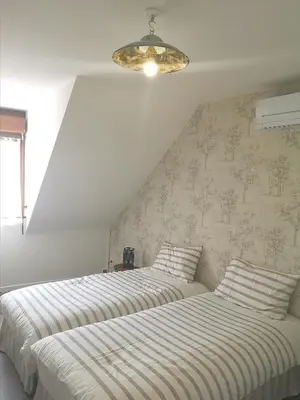 Un ou plusieurs lits dans un hébergement de l'établissement Cottage AU TERMINUS 3 climatisé
