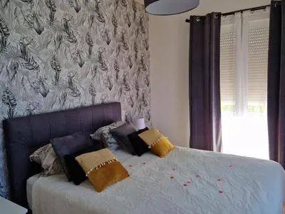 Un ou plusieurs lits dans un hébergement de l'établissement L'entre deux Eaux 'Maison' Balcon 'et Jardin