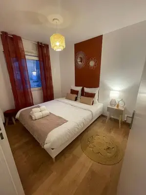 Un ou plusieurs lits dans un hébergement de l'établissement Appartement proche Disneyland