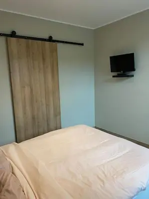 Un ou plusieurs lits dans un hébergement de l'établissement Gite du Pavillon