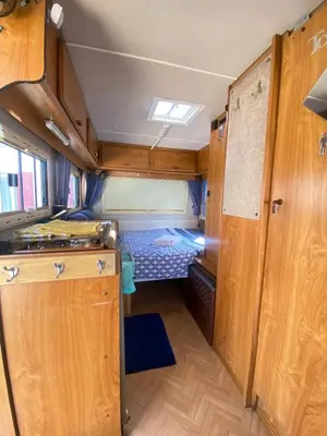 Un ou plusieurs lits dans un hébergement de l'établissement Camping-car vintage insolite